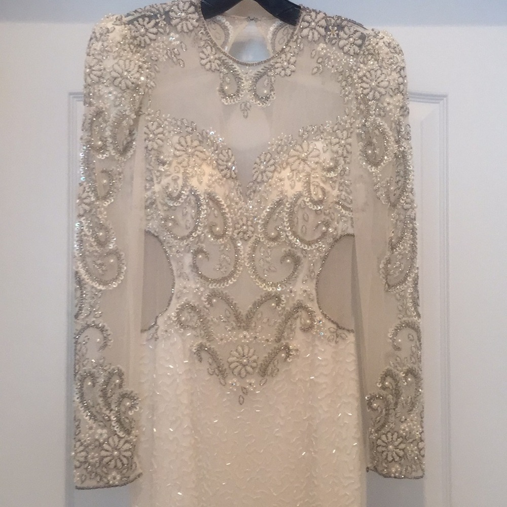 White floor length beaded column evening gown.